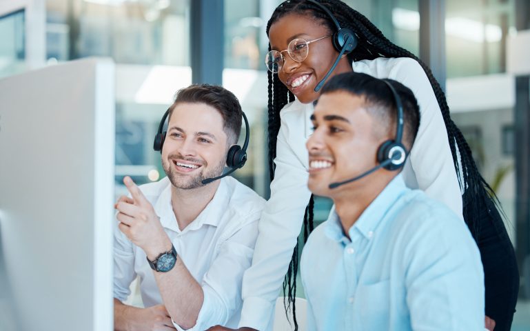 Customer service, call center or telemarketing team and manager or mentor looking happy reading online feedback or sale on website. Diversity in CRM, support and sales consultant training office.